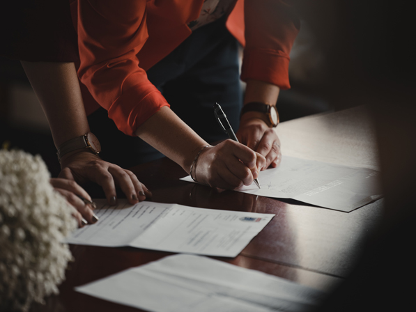 Woman and man signing a contract